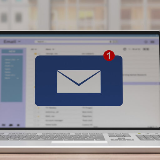 Laptop screen displaying an email inbox with a large email icon and a red notification badge indicating one new message.