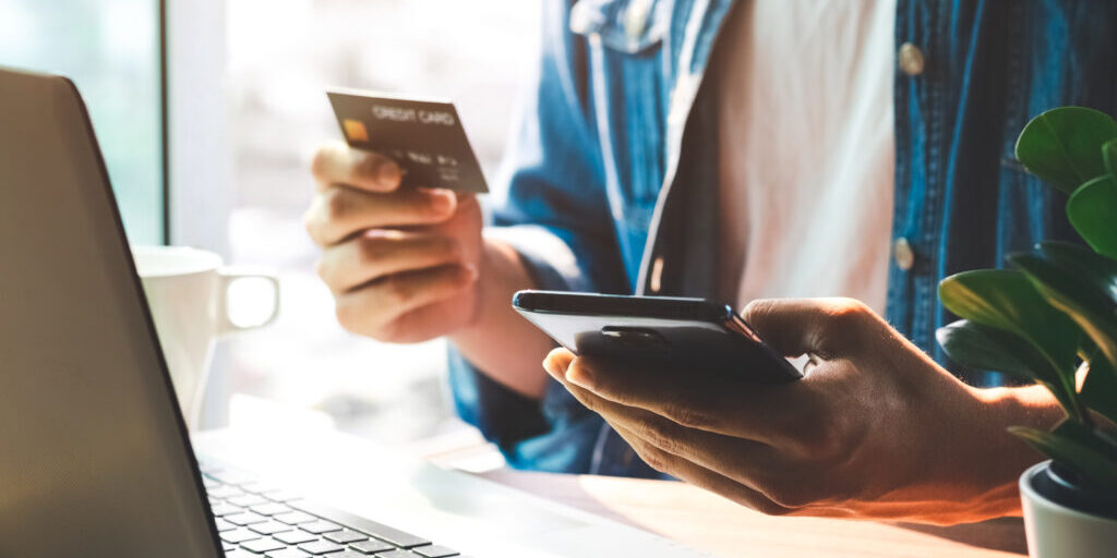 Men use their credit cards through mobile internet banking apps to shop online and digital payment ideas.