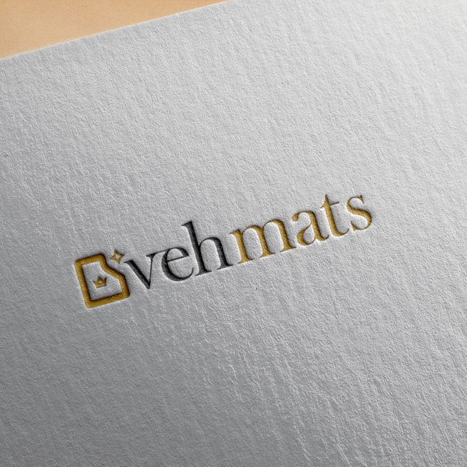 Embossed logo design on textured paper displaying the brand name 'vehmats' with a gold and black color scheme and a stylized emblem to the left.