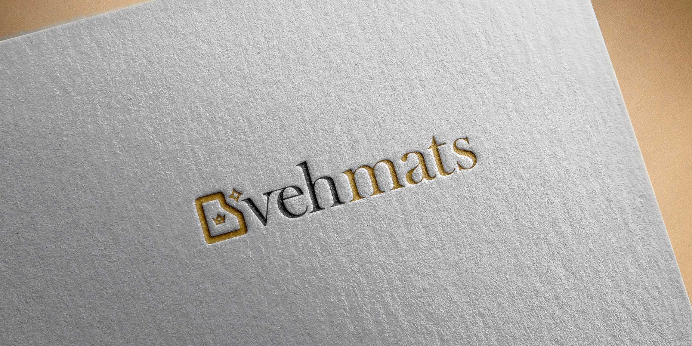 Embossed logo design on textured paper displaying the brand name 'vehmats' with a gold and black color scheme and a stylized emblem to the left.
